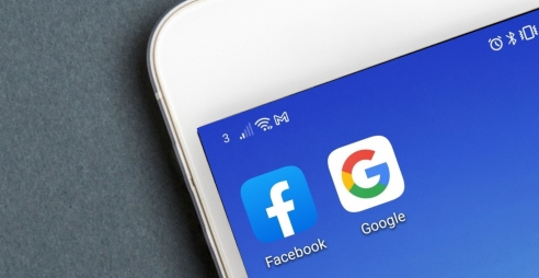 Facebook and Google icons on mobile screen