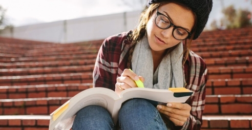 Student studying on university steps