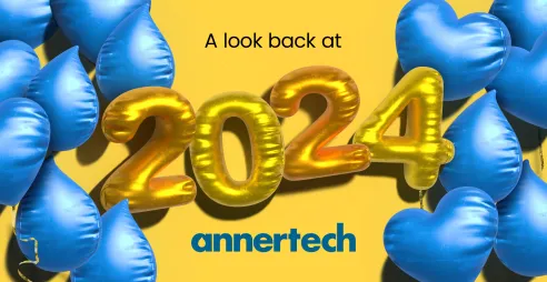 Blue Drupal and heart shaped balloons frame gold 2024 balloons, with the words “A look back at 2024“.