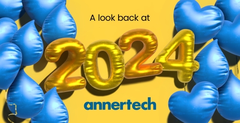 Blue Drupal and heart shaped balloons frame gold 2024 balloons, with the words “A look back at 2024“.