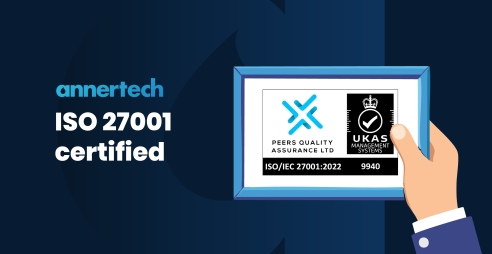 A graphic of a hand holding a framed ISO 27001 logo. Text says “Annertech: ISO27001 certified“.