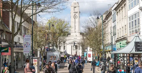 A bustling George Street with Luton Town Hall in the background.
