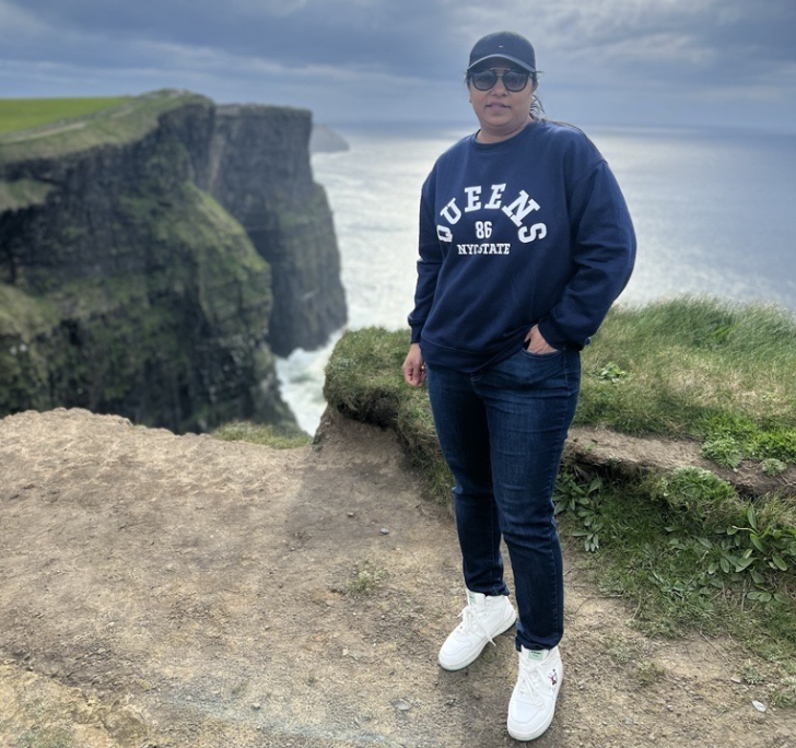 Sana Ather poses with the Cliffs of Moher in the background.