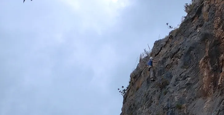 Bill Seremetis climbs a mountain near his house.