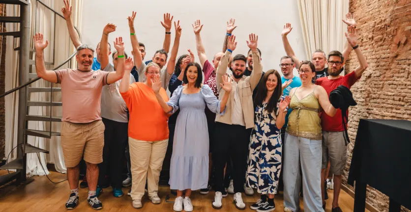 Team Annertech raise their hands in celebration at Born to Cook in Barcelona.