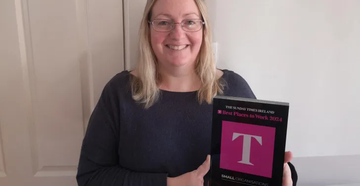 Stella Power holds the Best Places to Work plaque.