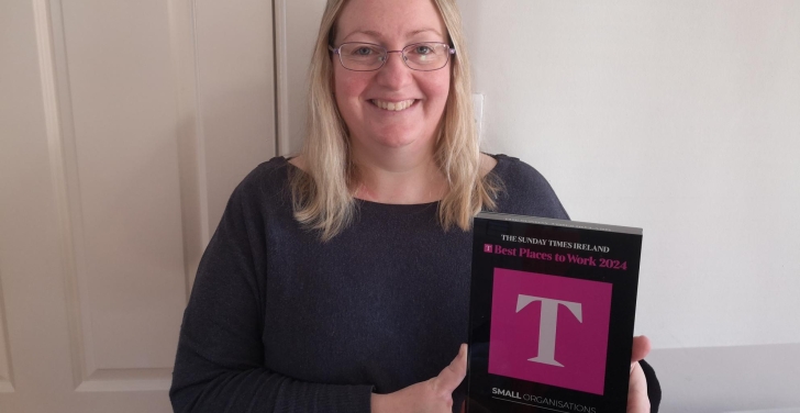 Stella Power holds the Best Places to Work plaque.