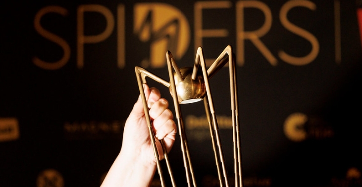 A Spider award is held aloft.
