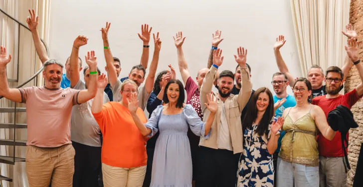 Team Annertech raise their hands in celebration at Born to Cook in Barcelona.