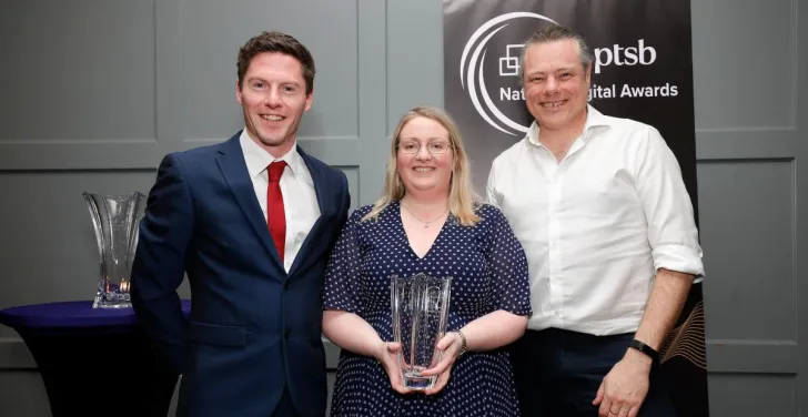 Stella Power and Anthony Lindsay hold a glass trophy at the National Digital Awards 2024