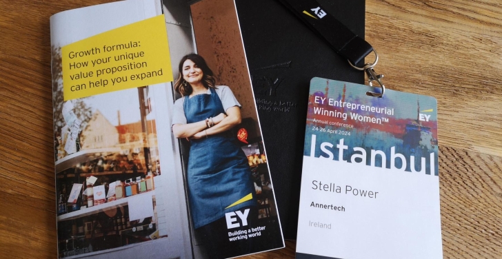 An EY winning women pamphlet lies next to Stella's event badge.