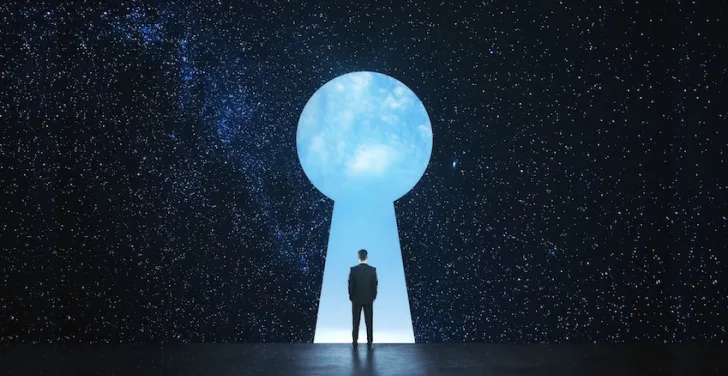 A man's figure is silhouetted against a keyhole.