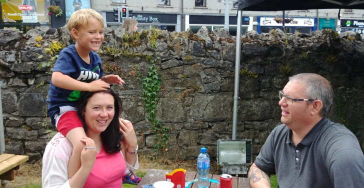 The Doubell family sit at a table outside a pub.