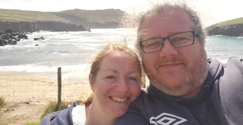 Stella and Dermot take a selfie with the sea in the background.