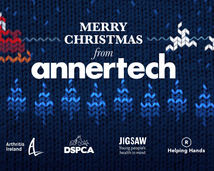 The background is a cross-stitch style image of Santa’s sleigh flying over a forest. The text says Merry Christmas from Annertech, and the logos of Arthritis Ireland, DSPCA, Jigsaw and Helping Hands are at the bottom of the image.