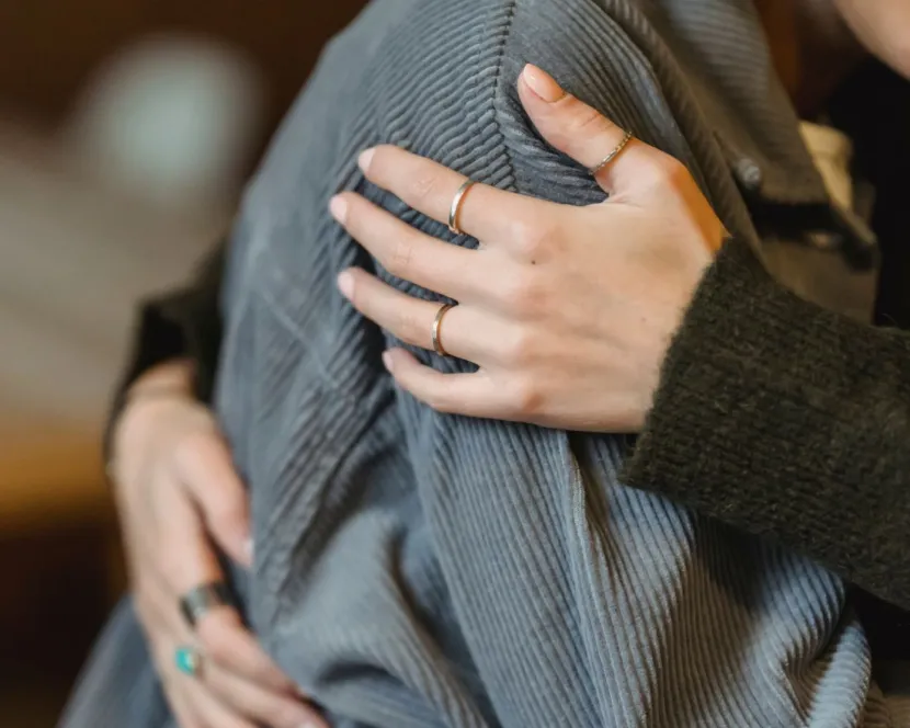 A person is comforted with a hug