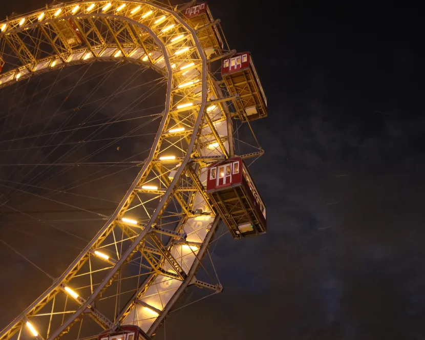 A Ferris wheel is lit up in the night sky