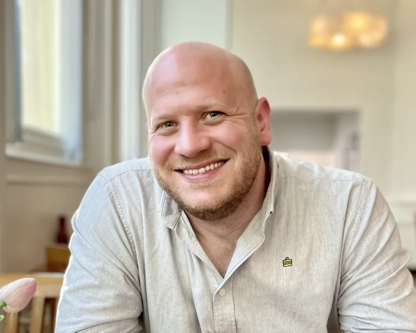 Josh Chamberlain sits at a restaurant table.