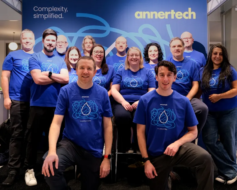 Team Annertech in front of the DrupalCon booth.
