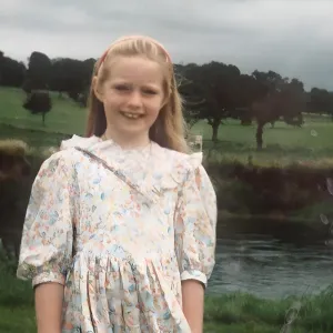 A young Stella Power stand beside a river