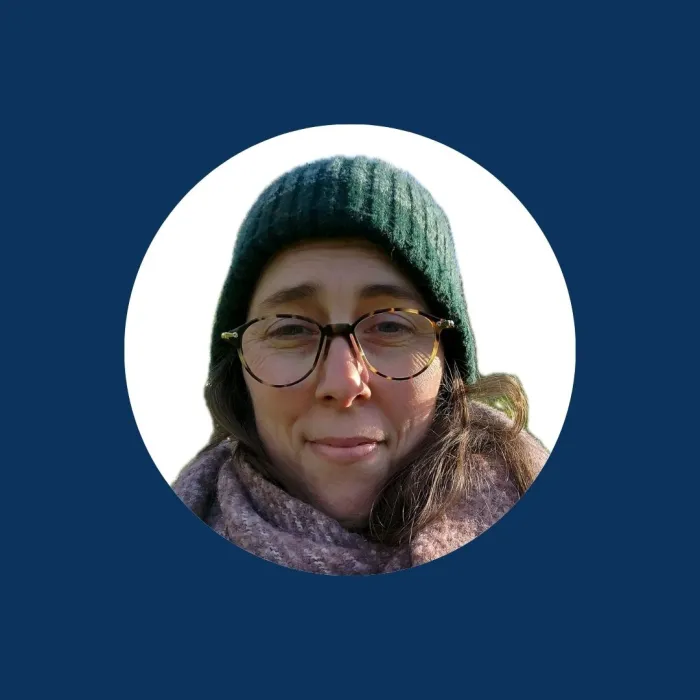 Karen Leech in a green beanie and maroon scarf