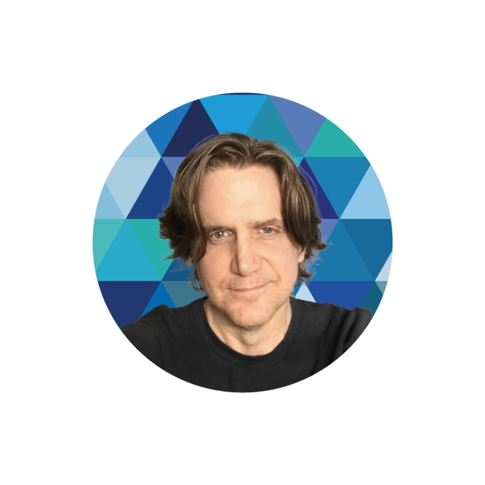 A head and shoulders image of John Albin in front of a kaleidoscope.