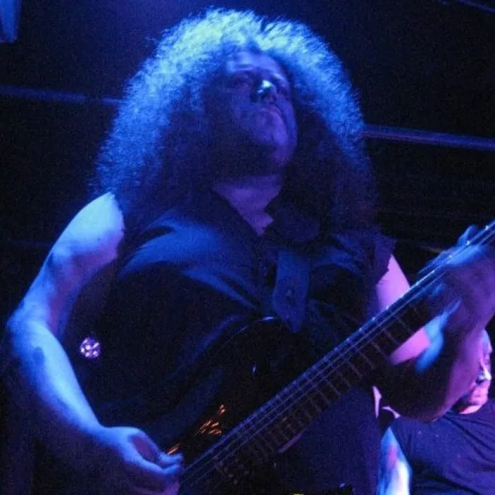 Dermot rocking out with an electric guitar on stage.