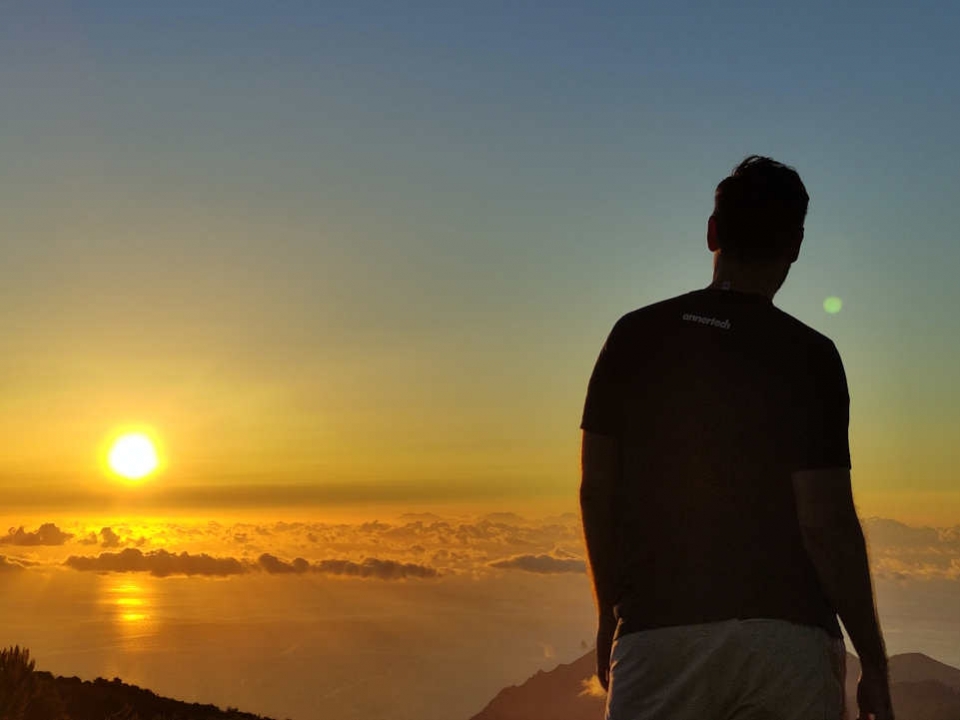 Adrien, wearing an Annertech tshirt, looking at the sun set