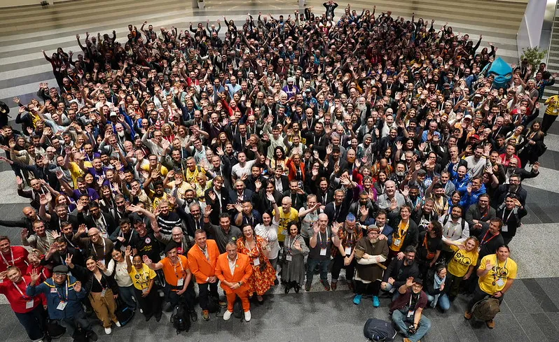 A group of people wave for the camera