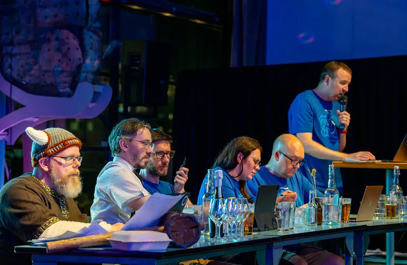 The judges table at Trivia Night, with quizmaster Alan Burke in the background.